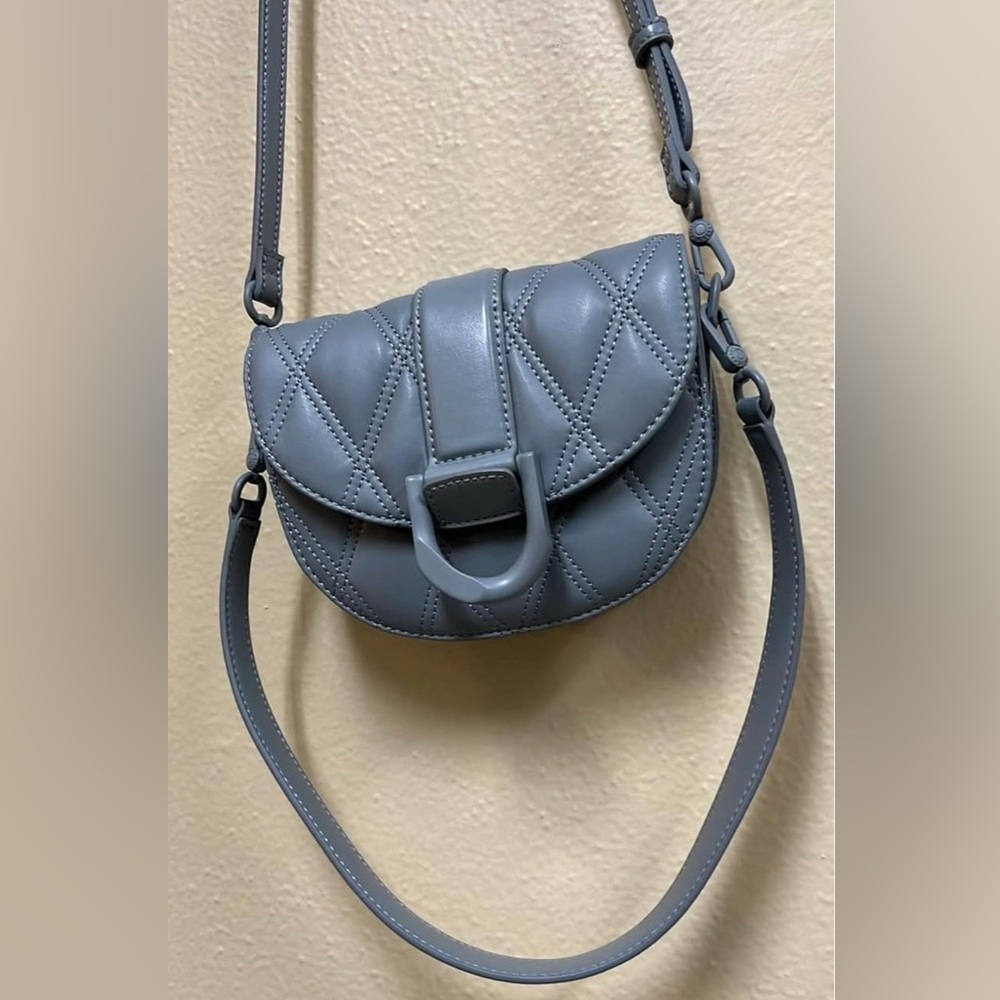 Charles & Keith Quilted Saddle Crossbody in blue